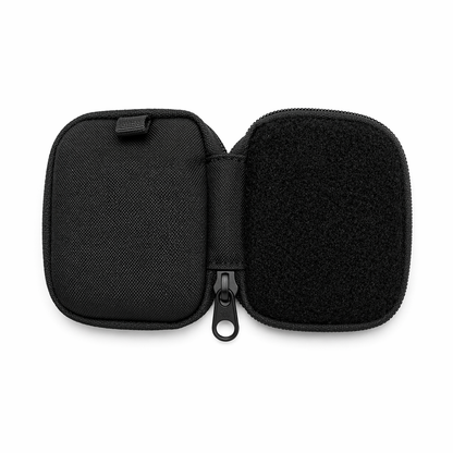 Open black micro EDC pouch with hook and loop panel on one side and Cordura fabric on the other, reverse coil zipper and compact design on white background by FirmGuards