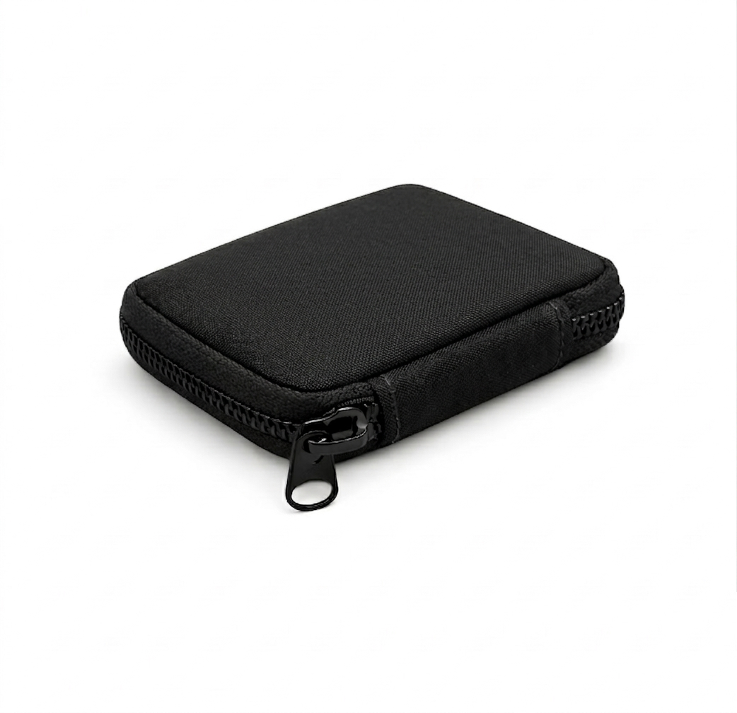 Compact black EDC pouch made from Cordura fabric with matte black zipper, shown in angled front view on a clean white background