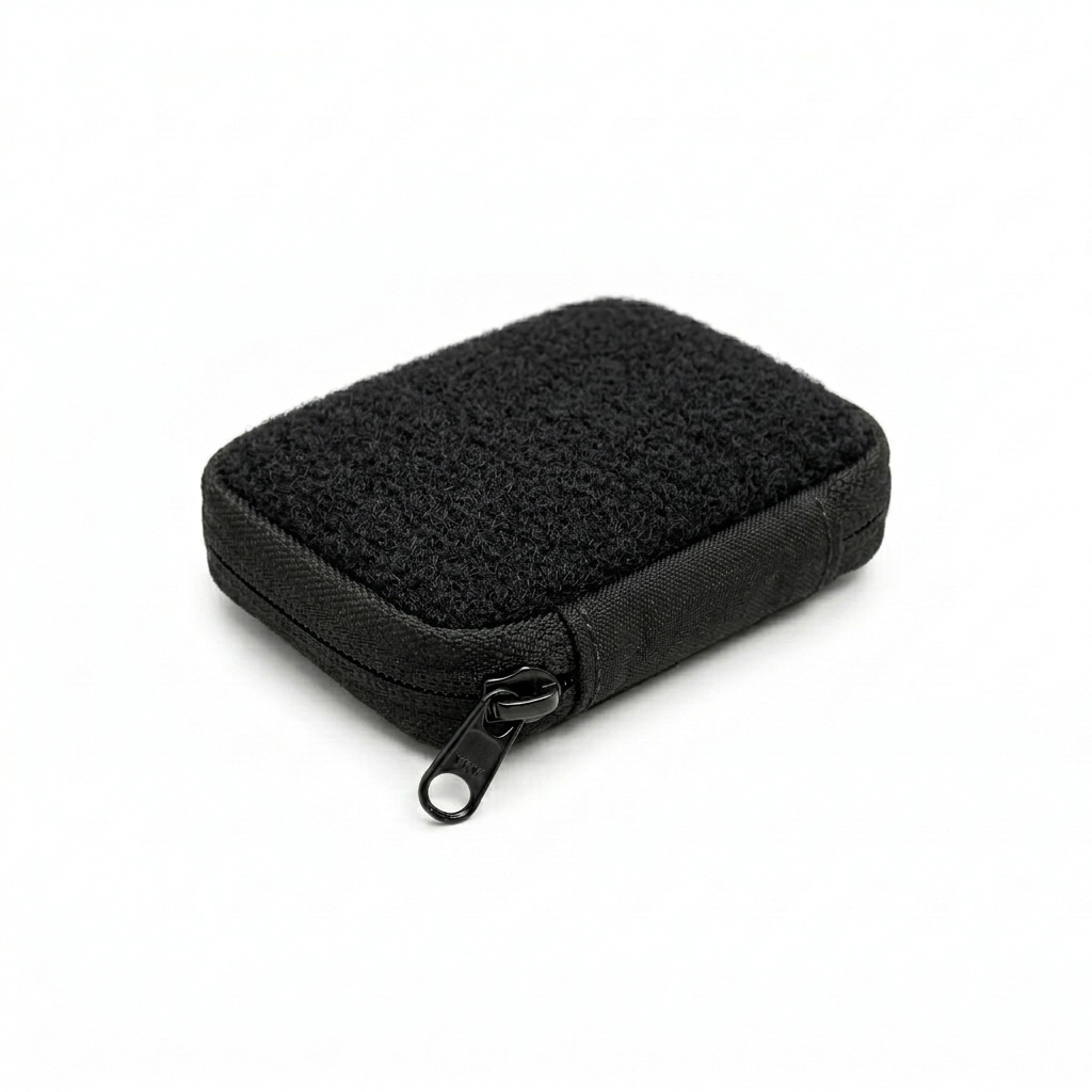 Firmguards Micro Kit Pouch with full hook and loop top panel in black Cordura featuring edge to edge loop Velcro and black zipper on white background