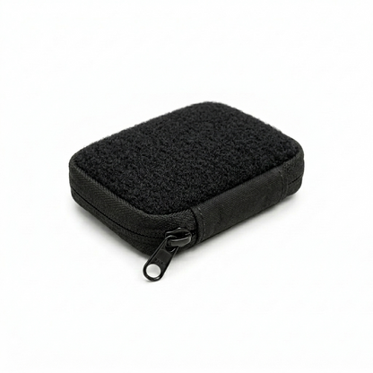 Firmguards Micro Kit Pouch with full hook and loop top panel in black Cordura featuring edge to edge loop Velcro and black zipper on white background