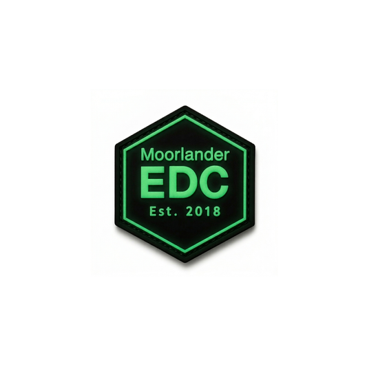 Glow in the dark Moorlander EDC PVC patch with green hexagon design and luminous lettering on black background