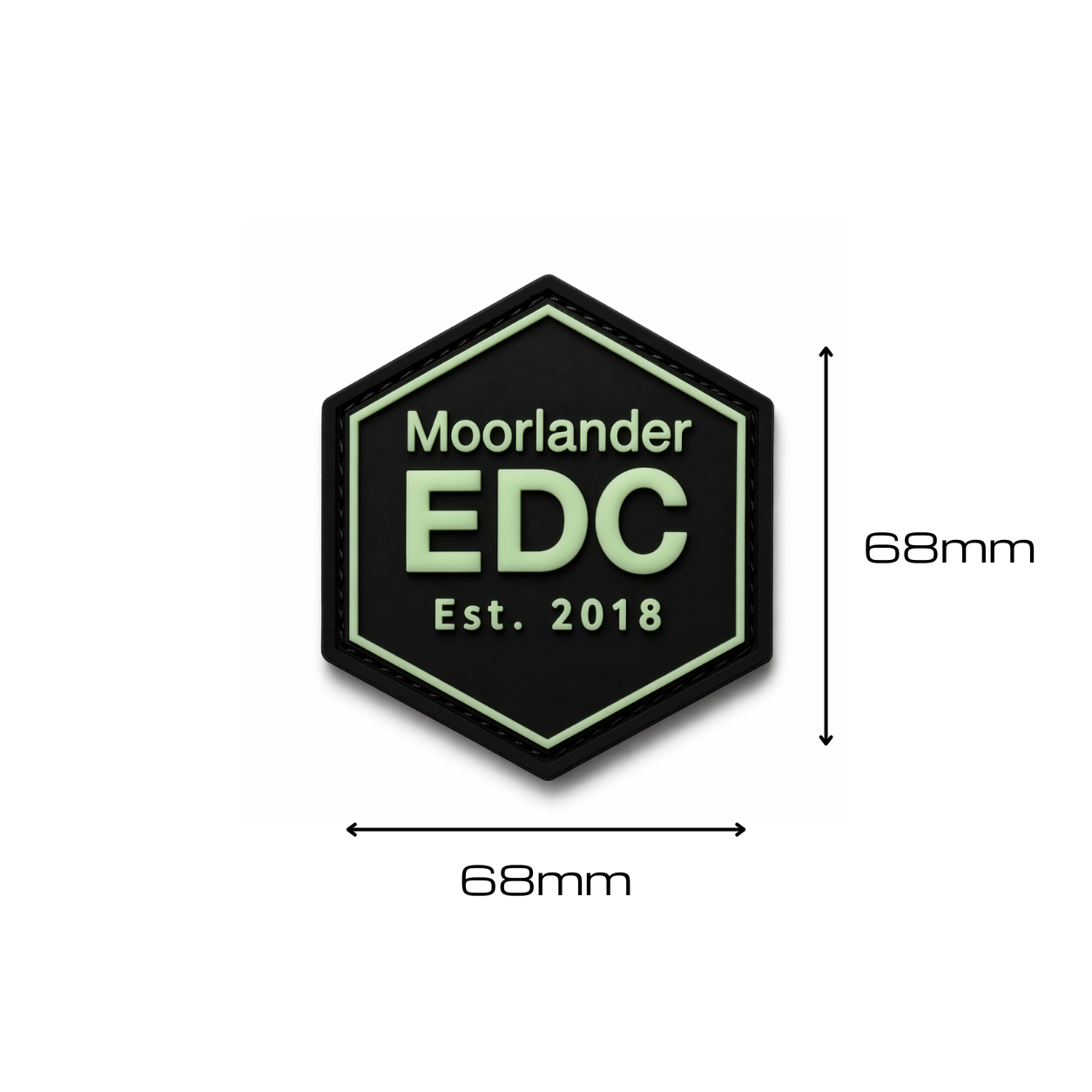 Moorlander EDC glow in the dark PVC morale patch in hexagon design with soft green GITD text on black base shown with 68 millimeter dimensions on a clean white background